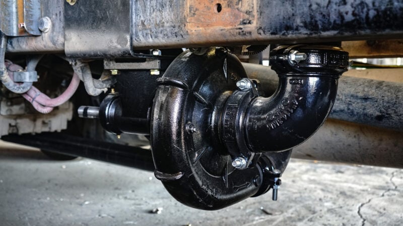 Access Truck Parts Water Pump installed onto a Truck Works Water Truck in their warehouse.